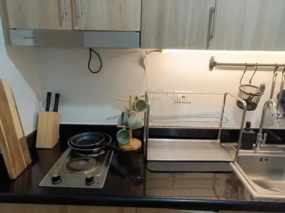 a small kitchen with a stove and a sink at Shore 2 Residences high speed Internet walking distance to MOA and IKEA in Manila