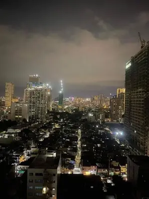 a view of a city at night with at Marias Suite near Manila bay FREE use of Pool in Manila
