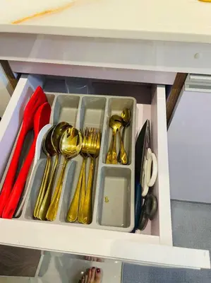 a drawer filled with gold utensils in a cabinet at Marias Suite near Manila bay FREE use of Pool in Manila