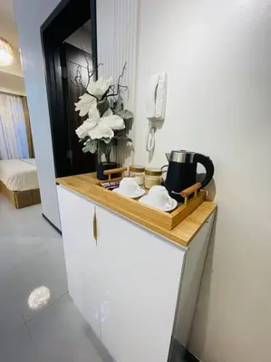 a counter with a tray with flowers and a phone at Marias Suite near Manila bay FREE use of Pool in Manila