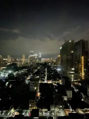 a view of a city at night with lights at Marias Suite near Manila bay FREE use of Pool in Manila