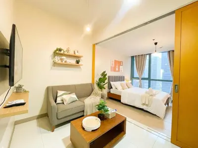 a living room with a bed and a couch at Prime BGC Condo: Uptown Mall & Hyatt #ournw21n in Manila