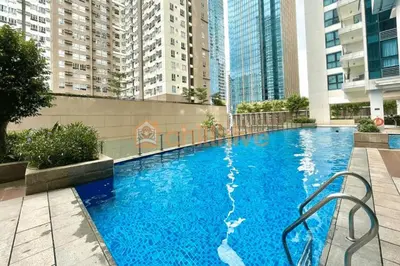 a large blue swimming pool with tall buildings at Prime BGC Condo: Uptown Mall & Hyatt #ournw21n in Manila