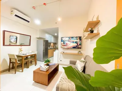 a living room with a couch and a table at Prime BGC Condo: Uptown Mall & Hyatt #ournw21n in Manila