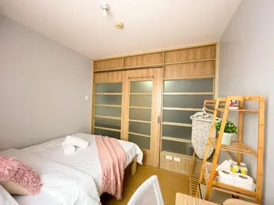a bedroom with a bed and a book shelf at Cozy & Affordable Stay Near Bgc #rt33005 in Manila