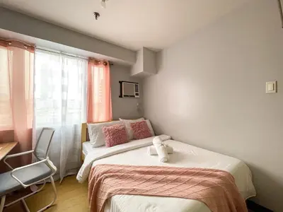a bedroom with two beds with a teddy bear on the bed at Cozy & Affordable Stay Near Bgc #rt33005 in Manila