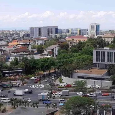 a city with a parking lot with cars and buildings at Affordable Condo Near Bgc, Venice Mall #rt33006 in Manila