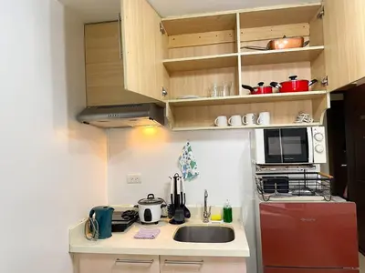 a small kitchen with a sink and a microwave at Affordable Condo Near Bgc, Venice Mall #rt33006 in Manila
