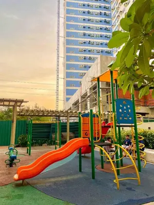 a playground with a slide in a park at Affordable Condo Near Bgc, Venice Mall #rt33006 in Manila