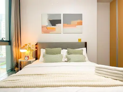 a bedroom with a large bed with green pillows at Prime BGC Condo at Uptown Area #oursw11g in Manila