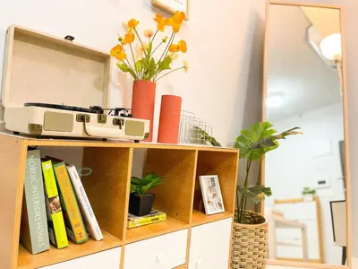 a book shelf with a radio and books at Prime BGC Condo at Uptown Area #oursw11g in Manila