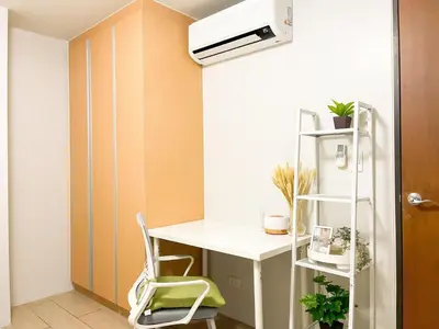 a small room with a desk and a heater at Prime BGC Condo at Uptown Area #oursw11g in Manila