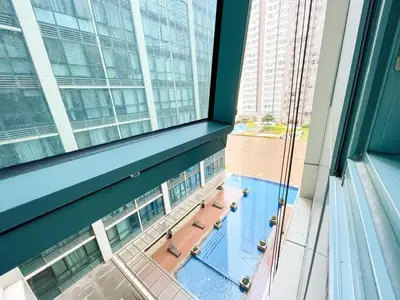 an overhead view of a swimming pool in a building at Prime BGC Condo at Uptown Area #oursw11g in Manila