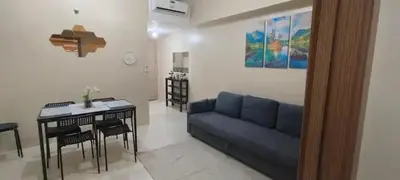 a living room with a blue couch and a table at 1Bedroom Accommodation Near Airport in Manila