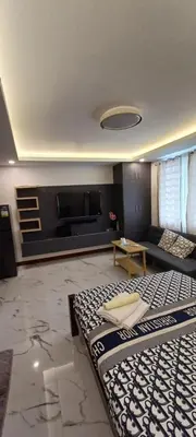 a living room with a couch and a television at B Mary's Staycation in Tanza CAVITE Condo Type with balcony 2 person in Tanza