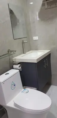 a bathroom with a white toilet and a sink at B Mary's Staycation in Tanza CAVITE Condo Type with balcony 2 person in Tanza