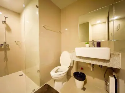 a bathroom with a toilet and a sink and a shower at Premium BGC 1BR Near Grand Hyatt #upt119h in Manila