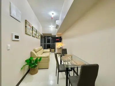 a living room with a couch and a table at Prime BGC Condo Near Grand Hyatt #upt131q in Manila