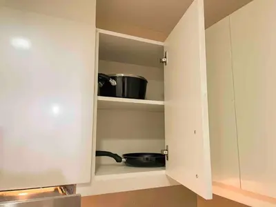 a cupboard with a pot and a pan in it at Exclusive BGC Condo at Uptown Area #upt136d in Manila