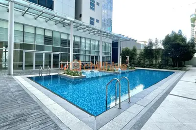 a large swimming pool in front of a building at Exclusive BGC Condo at Uptown Area #upt136d in Manila
