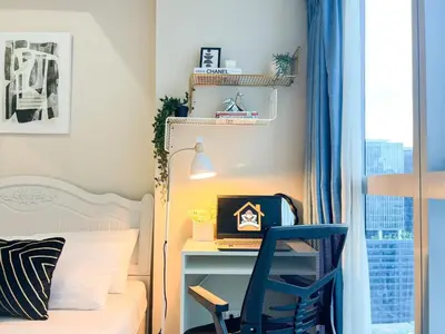 a bedroom with a bed and a desk and a chair at Upscale BGC Stay Near Mitsukoshi #upt130g in Manila