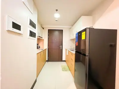 a kitchen with a stainless steel refrigerator and a door at Upscale BGC Stay Near Mitsukoshi #upt130g in Manila