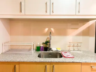 a kitchen with a sink and a counter top at Upscale BGC Stay Near Mitsukoshi #upt130g in Manila