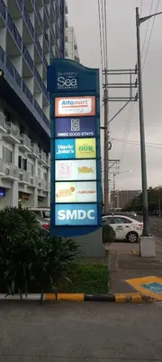 a sign in a parking lot next to a building at BLUE sea Residences in Manila