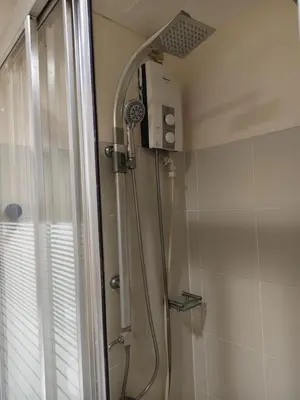 a shower with a shower head in a bathroom at BLUE sea Residences in Manila