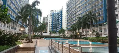 a swimming pool in a city with tall buildings at BLUE sea Residences in Manila