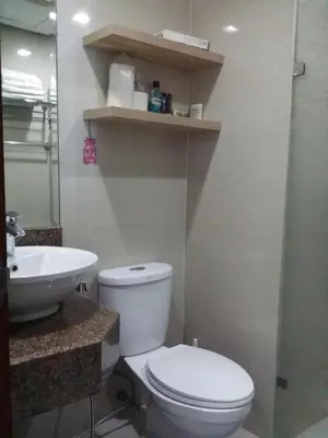 a bathroom with a white toilet and a sink at Eastwood Legrand Tower 3 condominium in Manila