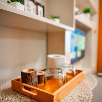 a wooden tray with two glasses on a shelf at 633 Air Condo Pool View Escape Cozy 1BR w Sofa Bed in Manila