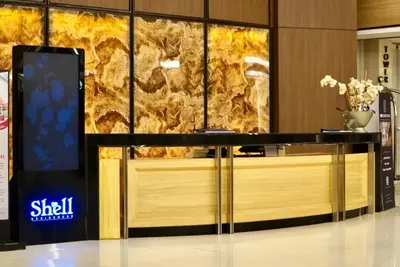 a lobby with a counter with a marble wall at 633 Air Condo Pool View Escape Cozy 1BR w Sofa Bed in Manila