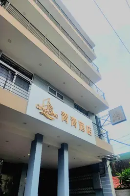 a building with a sign on the side of it at Qingqing Hotel Pasay Manila near MOA in Manila