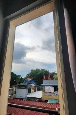 a window view of a city from a roof at Qingqing Hotel Pasay Manila near MOA in Manila