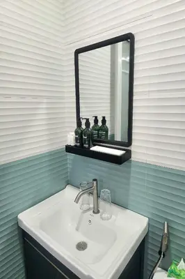 a bathroom with a sink and a mirror at Qingqing Hotel Pasay Manila near MOA in Manila