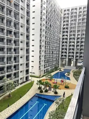 a view of two tall buildings and a swimming pool at Georgia Luxe Suite at Shore 2 MOA in Manila