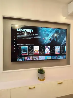 a flat screen tv hanging on a wall at Georgia Luxe Suite at Shore 2 MOA in Manila