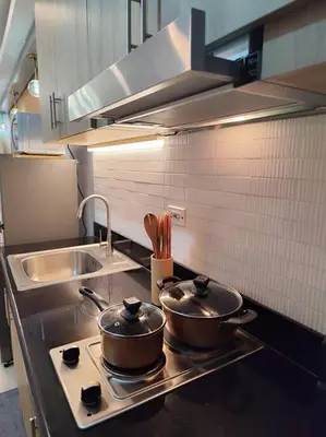 two pots sitting on top of a stove in a kitchen at Georgia Luxe Suite at Shore 2 MOA in Manila