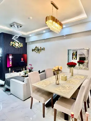 a dining room with a table and a couch at Gina Staycation Condo Unit in Manila