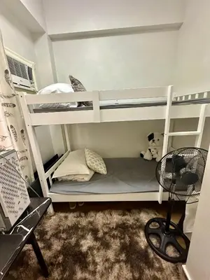 a bedroom with two bunk beds with a teddy bear at Gina Staycation Condo Unit in Manila