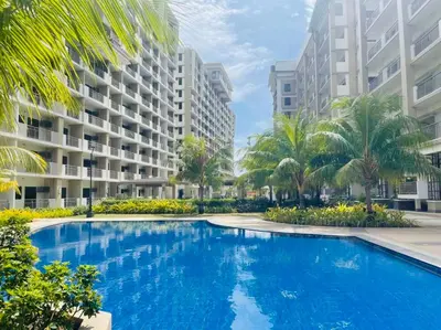 an image of a swimming pool in front of apartment buildings at Gina Staycation The Atherton DMCI Parañaque in Manila