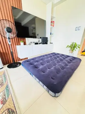a living room with a large purple bed in a room at LA Amore Place Aspire Tower Nuvo City Libis in Manila