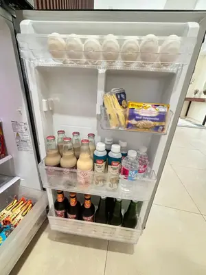 an open refrigerator filled with lots of food and drinks at LA Amore Place Aspire Tower Nuvo City Libis in Manila