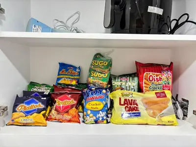 a refrigerator filled with lots of different types of snacks at LA Amore Place Aspire Tower Nuvo City Libis in Manila