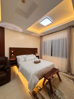a bedroom with a large bed and a window at LA Amore Place Aspire Tower Nuvo City Libis in Manila