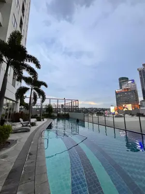 a swimming pool on the side of a building at LA Amore Place Aspire Tower Nuvo City Libis in Manila
