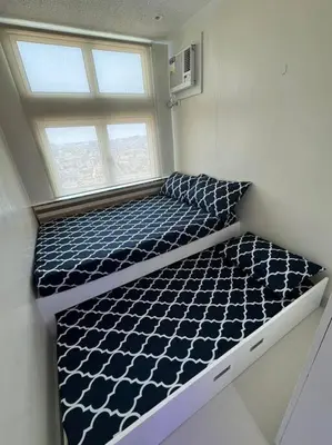 a bed in a room with a window at The Quin Place 1BR 200Mbps WIFI in Manila