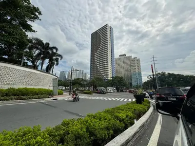 a person riding a motorcycle on a city street at Fully Furnished 1BR Ridgewood Towers with 200Mbps WIFI in Manila