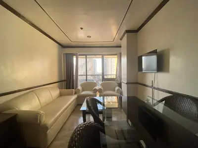 a living room with a couch and a table at Fernandina 88 Suites Condo in Manila